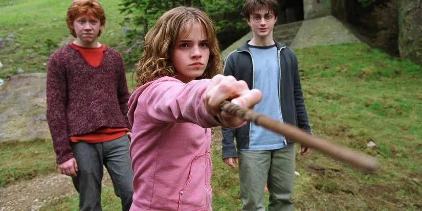 Hermione pointing her wand at Malfoy with Harry and Ron behind her in Prisoner of Azkaban.