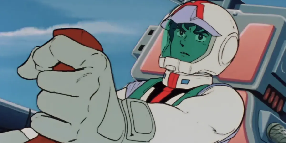 Amuro Ray wearing a normal suit and piloting the Gundam, one hand on its controls in Mobile Suit Gundam Episode 15