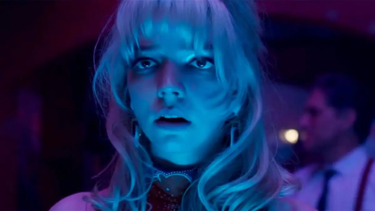 Anya Taylor-Joy, lit in neon blue and terrified, in Last Night in Soho