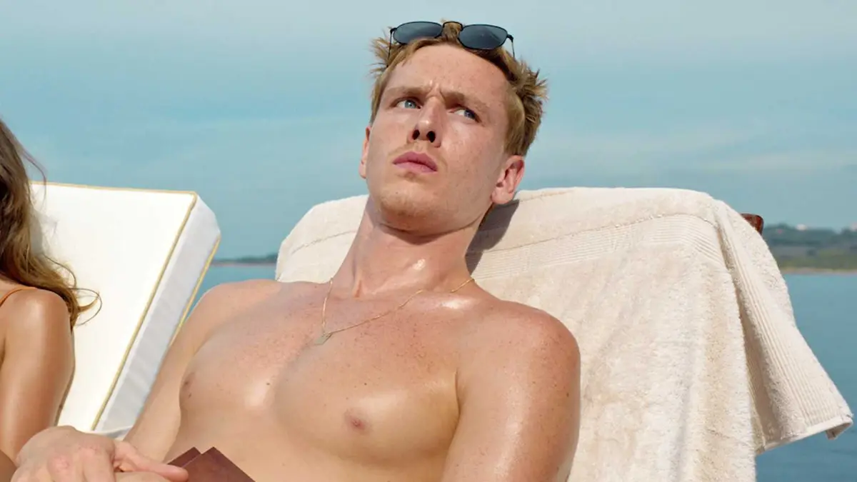 Harris Dickinson as Carl looking sideways while subathing in Triangle of Sadness