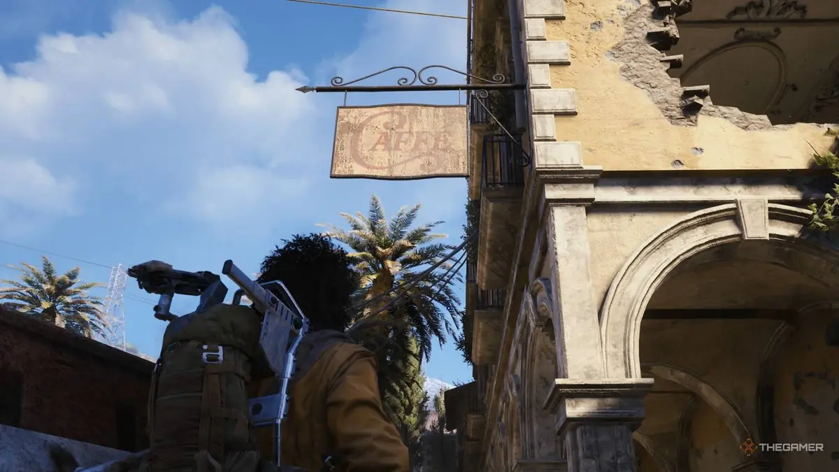 Player raider looking up at a sign outside a ruined cafe that says cafe in Italian in Arc Raiders.