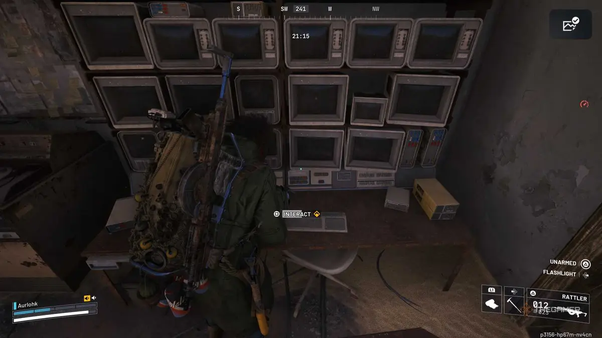Player raider interacting and using a keyboard on a desk surrounded by monitors in Arc Raiders.
