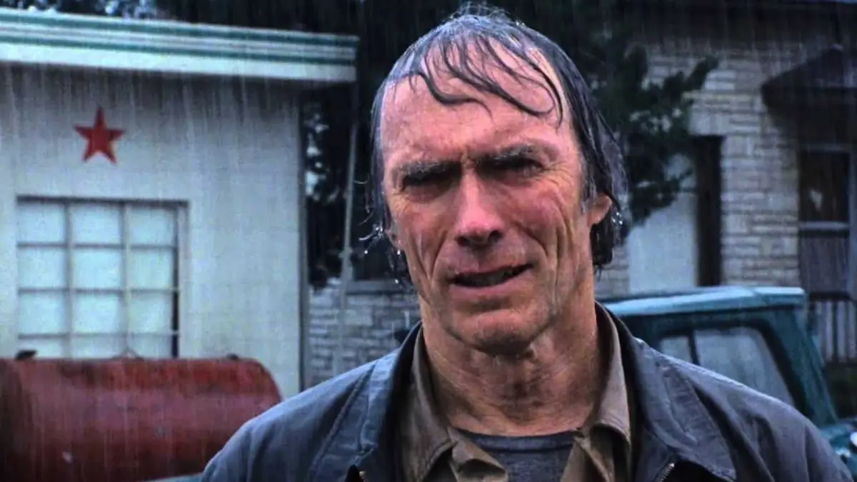 Clint Eastwood stands in the rain in The Bridges of Madison County