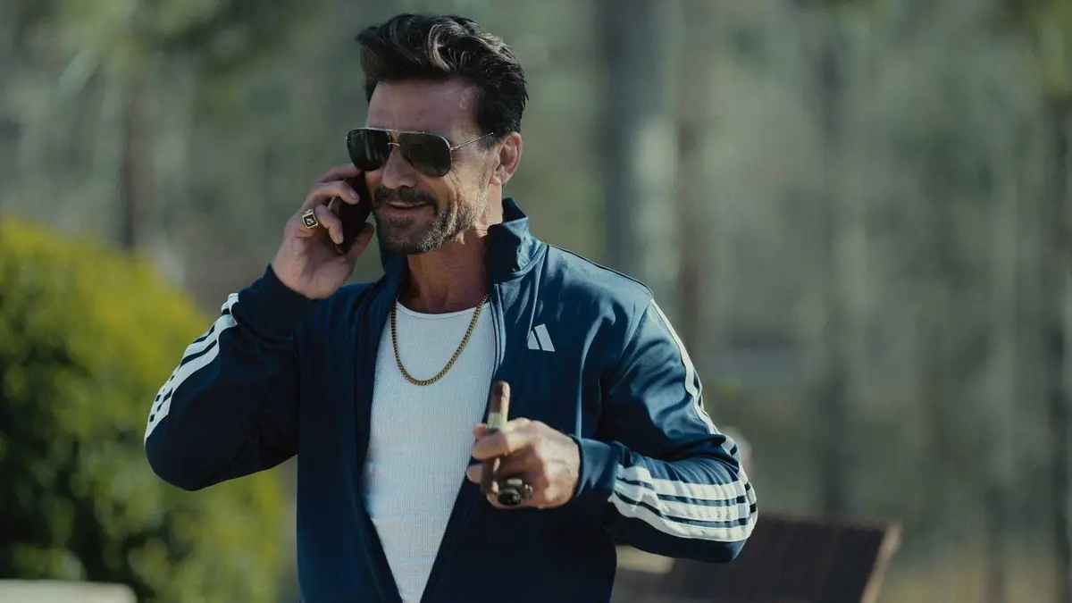 Frank Grillo as Bill Bevilaqua smoking a cigar and talking on the phone in Tulsa King season 3