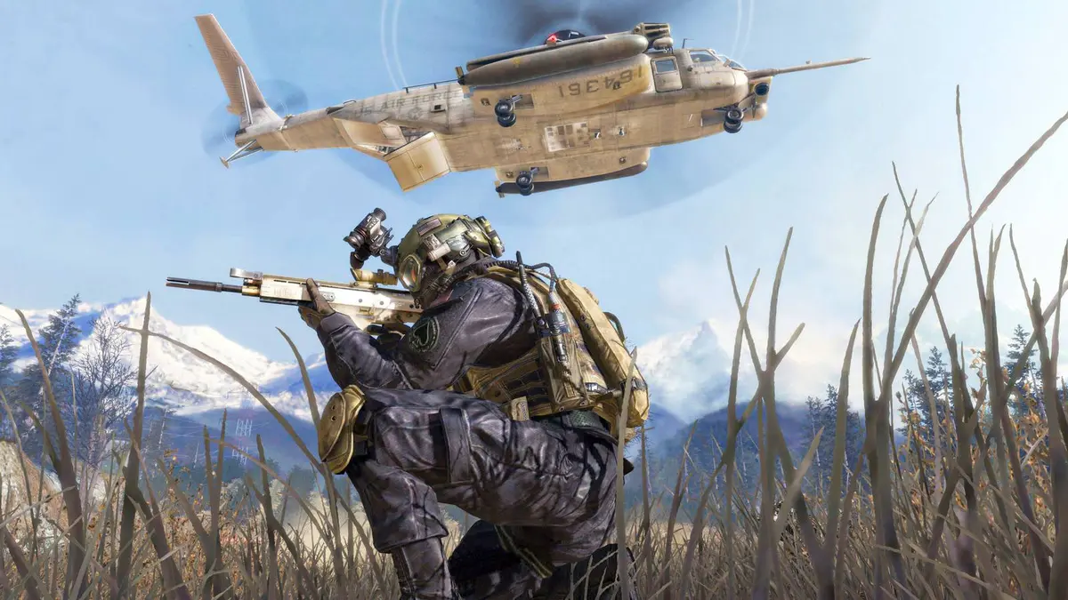 Call of Duty: Modern Warfare 2 soldier crouched in the grass with a helicopter overhead.