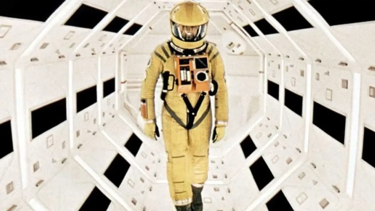 Man walks in space ship wearing yellow space suit in 2001 A Space Odyssey