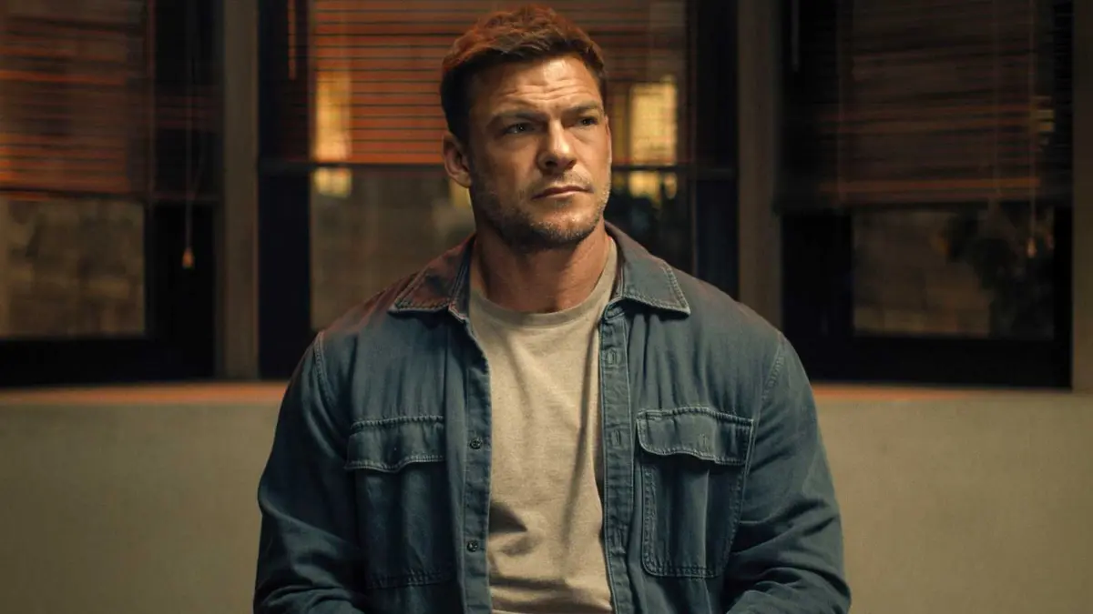Alan Ritchson sitting in Reacher season 4