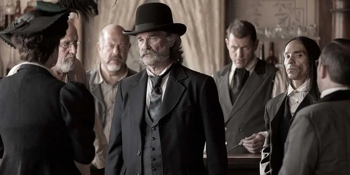 Kurt Russell as Sheriff Franklin Hunt wearing a derby hat and black western tuxedo in Bone Tomahawk