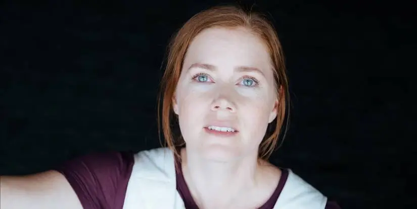 Amy Adams smiling while looking up in Arrival