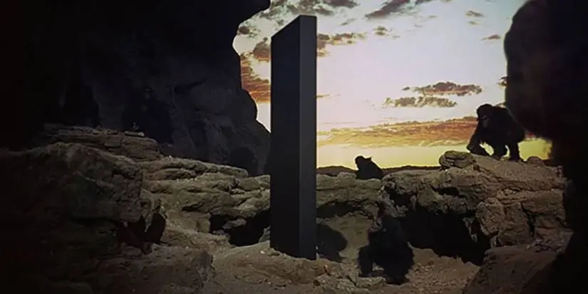 A group of hominins staring at the monolith from the movie 2001: A Space Odyssey (1968)