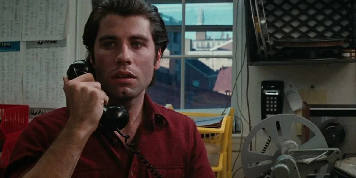 John Travolta as Jack Terry holding a phone to his face in Blow Out