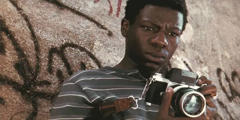 Rocket from City of God holding a camera