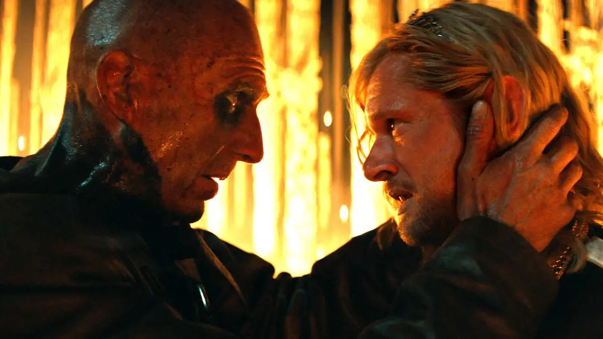 Ralph Fiennes' Dr. Ian Kelson holding Jack O'Connell's Jimmy by the face in 28 Years Later: The Bone Temple