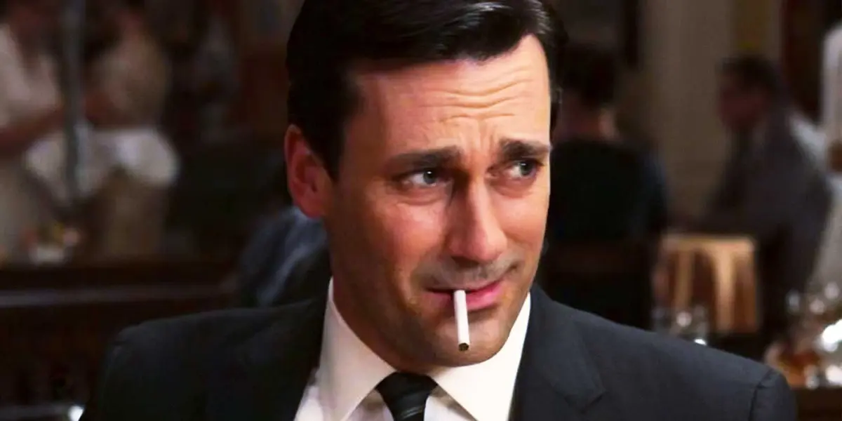 Don Draper in Mad Men smokes a cigarette with an incredulous expression