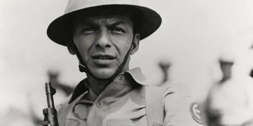 Angelo Maggio (Frank Sinatra) wearing an army helmet in From Here to Eternity