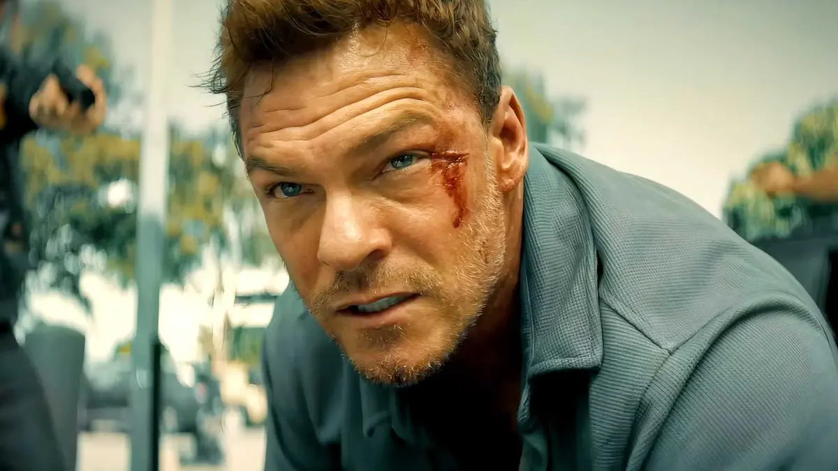 Alan Ritchson with a cut on his face is serious in Runner