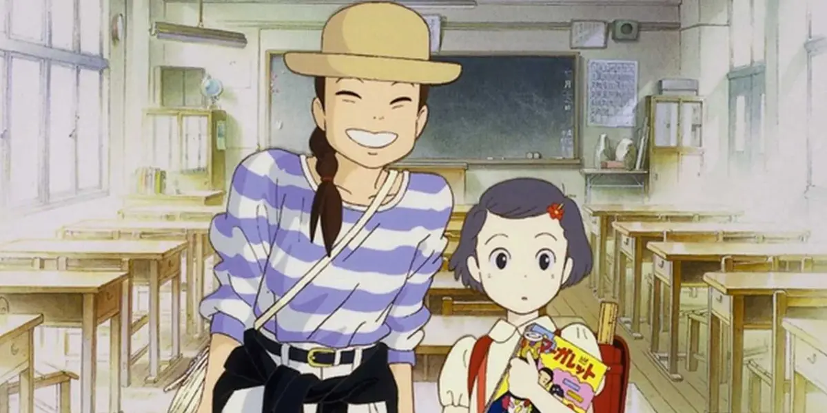 Adult Taeko Okajima smiles next to her child self in a classroom in Only Yesterday.