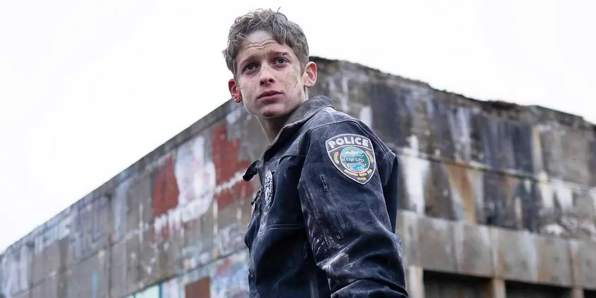 Joe Freeman as Luke Ellis in a police jacket in The Institute Season 2