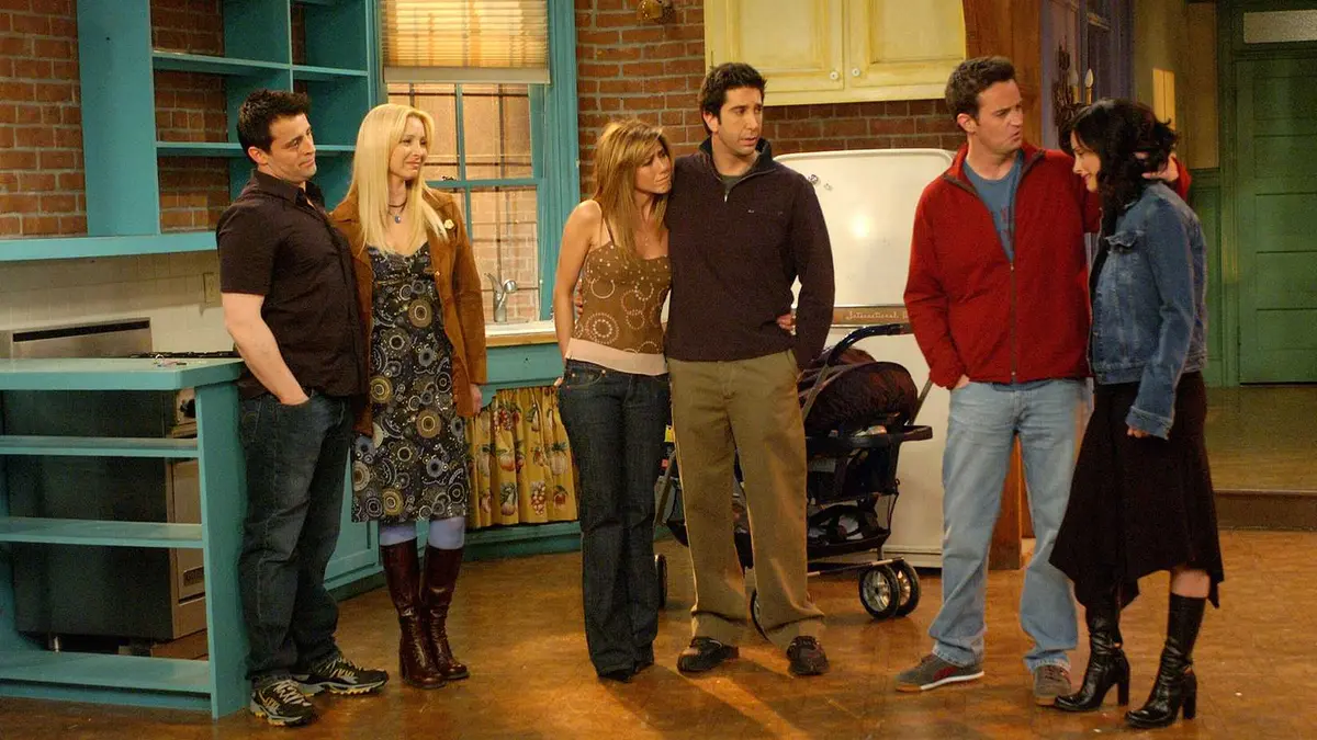 Friends main cast in Monica's empty apartment in the show's finale