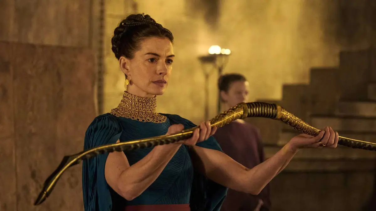 Anne Hathaway holds a bow as Penelope in The Odyssey.