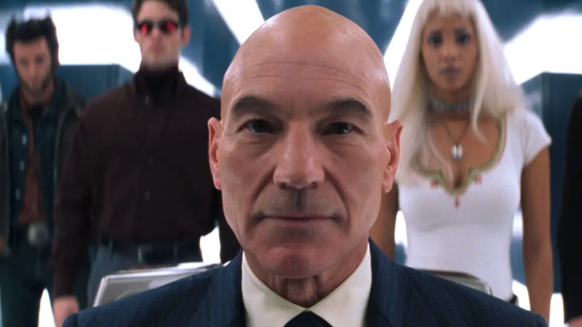 Patrick Stewart as Professor X in X-Men with Wolverine, Cyclops, and Storm behind him
