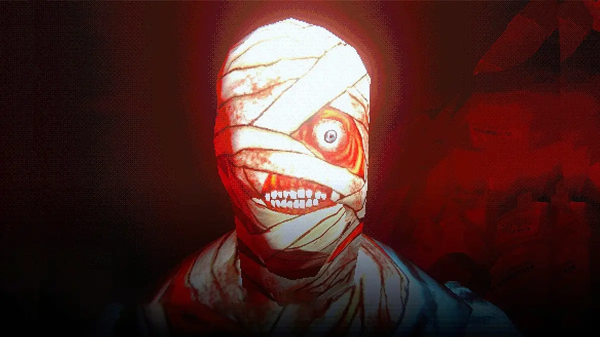 A bandaged zombie-like creature with one big eye and very red flesh and a menacing set of teeth, stares at the camera.