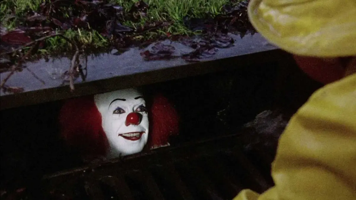 Pennywise talks to Georgie through the storm drain in Stephen King's It