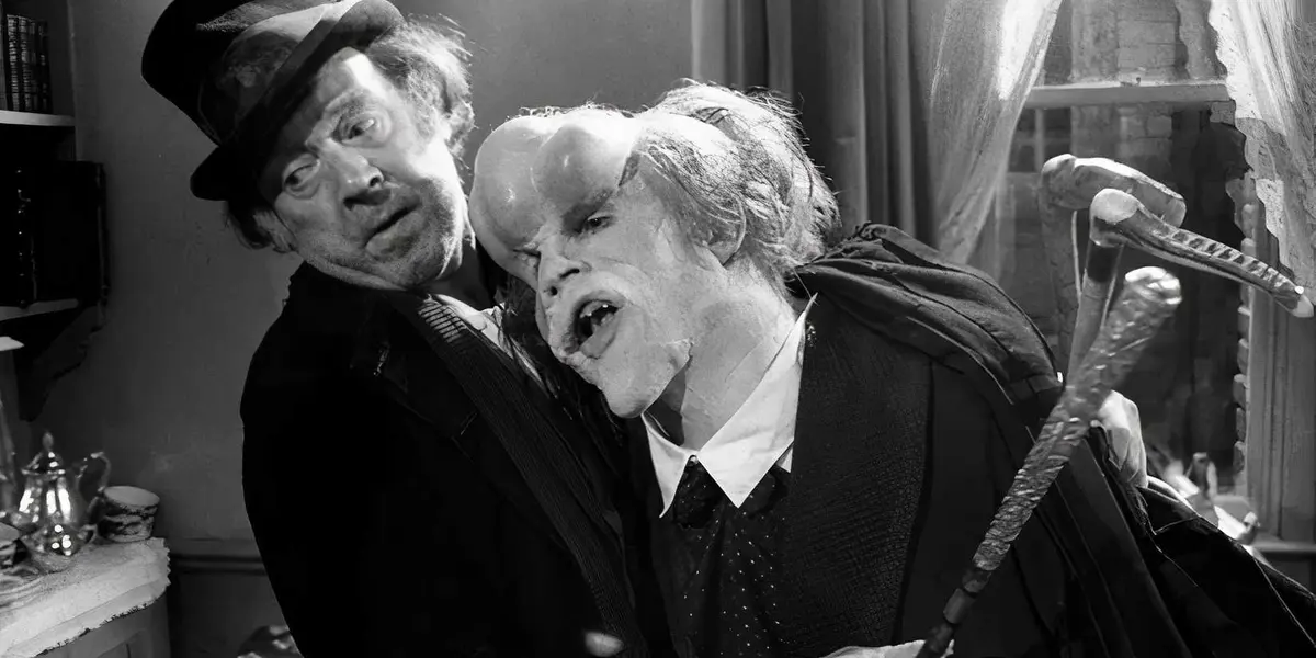 John Hurt as Joseph Merrick leans on Freddie Jones as Bytes in The Elephant Man