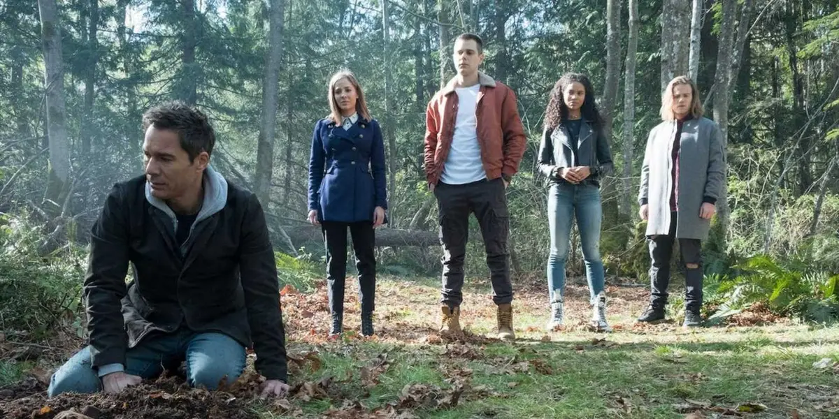 The core characters investigating in the woods in Travelers season 3