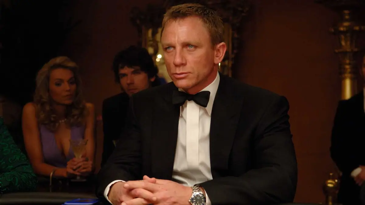 Daniel Craig as James Bond, sitting at a poker table in Casino Royale