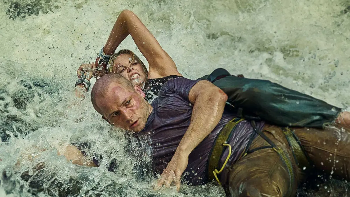 Charlize Theron and Taron Egerton fighting in the water in Apex