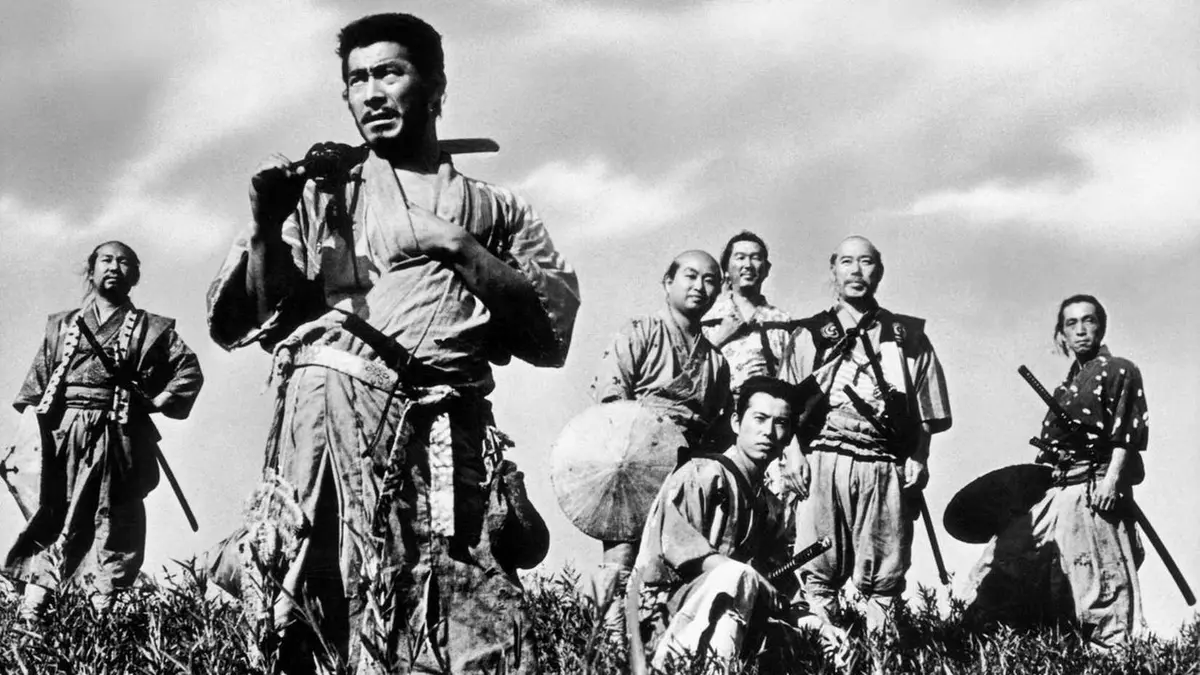 The titular samurai sit on a hill in Seven Samurai