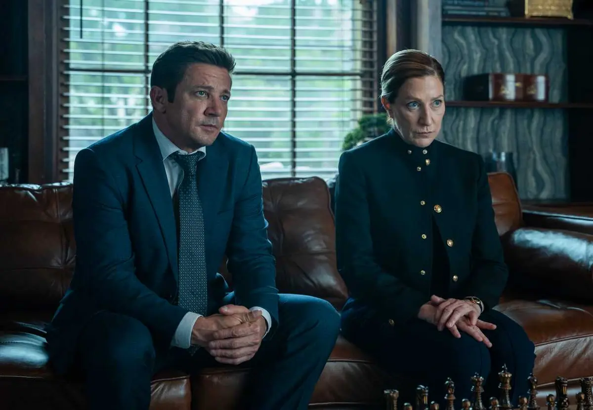 Jeremy Renner and Edie Falco sitting together in Mayor of Kingstown season 5