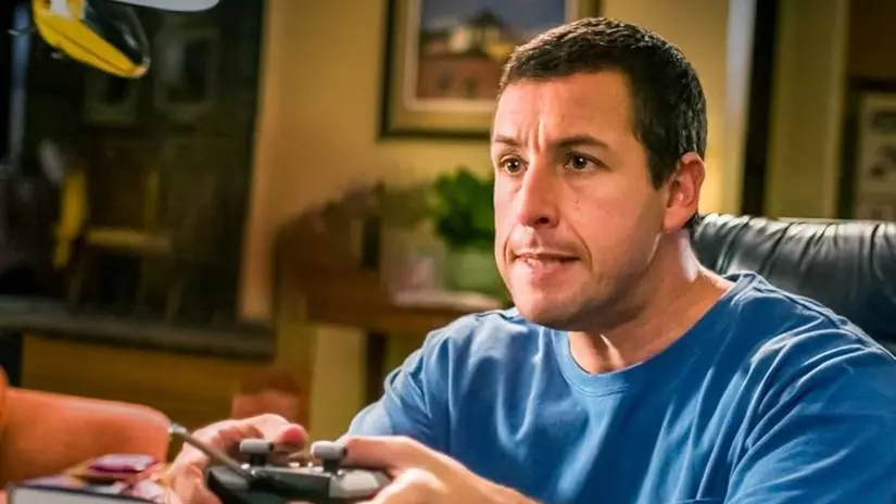 Adam Sandler as Michael Newman frustratedly holding a remote control