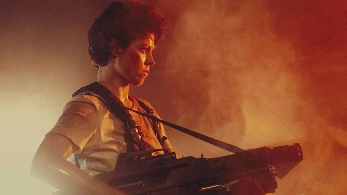 Ripley holds a big gun in Aliens