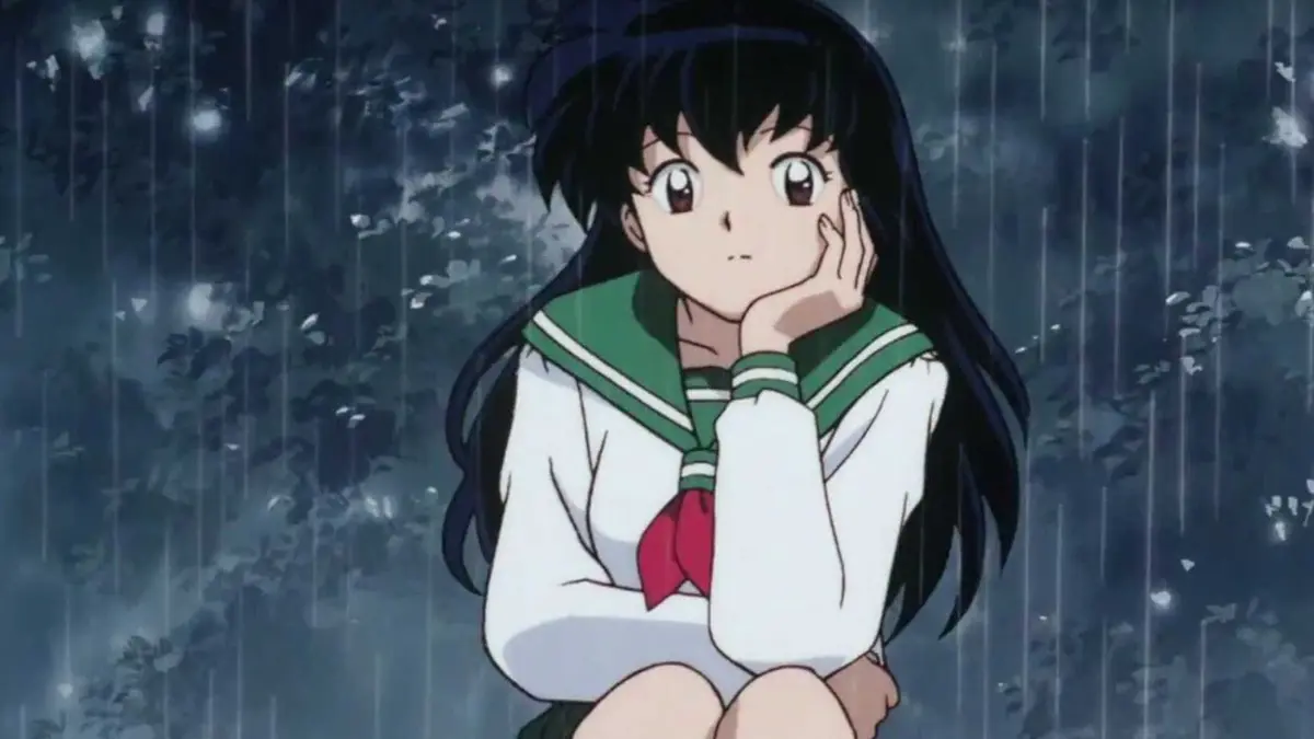 Kagome Higurashi sitting in a rainy forest from the anime Inuyasha.
