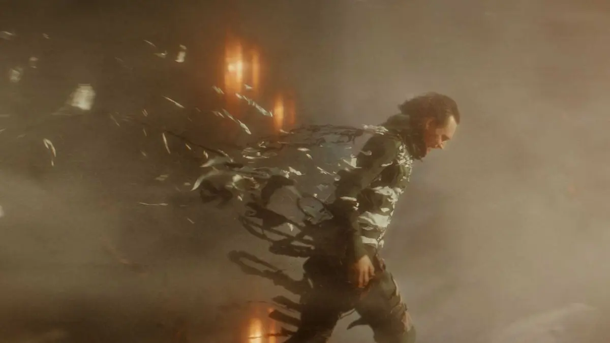 Loki (Tom Hiddleston) walking through a time storm in Loki.