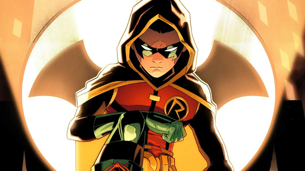 Damian Wayne crouches in front of Batman's Bat-Signal