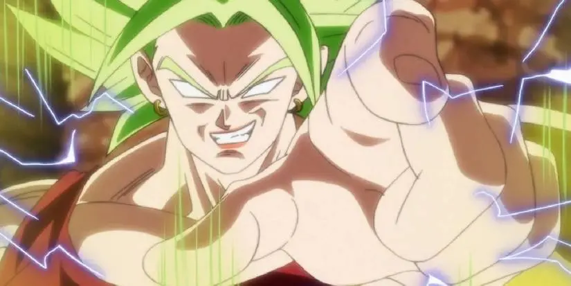 Super Saiyan Berserk Kale smirks and points at the viewer as energy crackles around her in Dragon Ball Super.