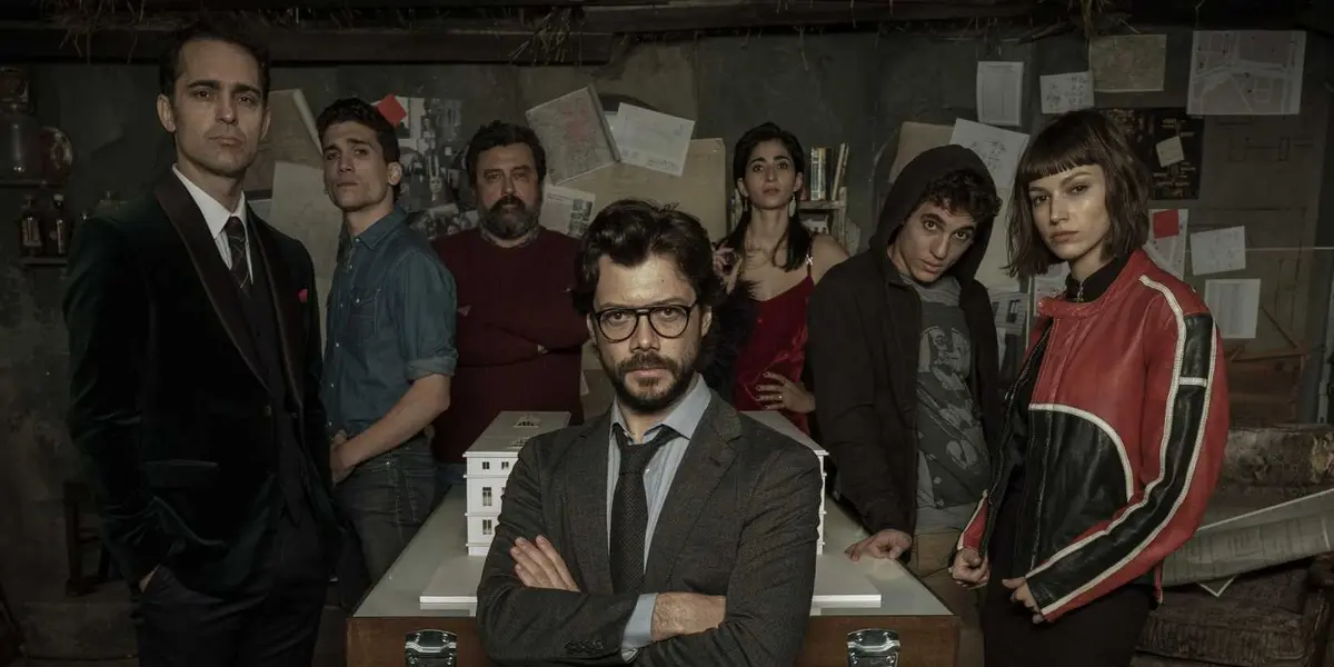The Professor sitting in front of Berlin, Denver, Moscow, Nairobi, Rio, and Tokyo in Money Heist