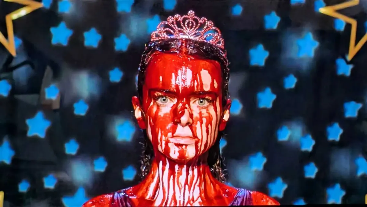 Summer H Howell as Carrie White with a hyper-focused stare covered in blood in Carrie