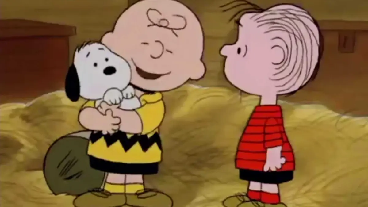 Charlie Brown hugging Snoopy in the Peanuts animated special Snoopy's Reunion