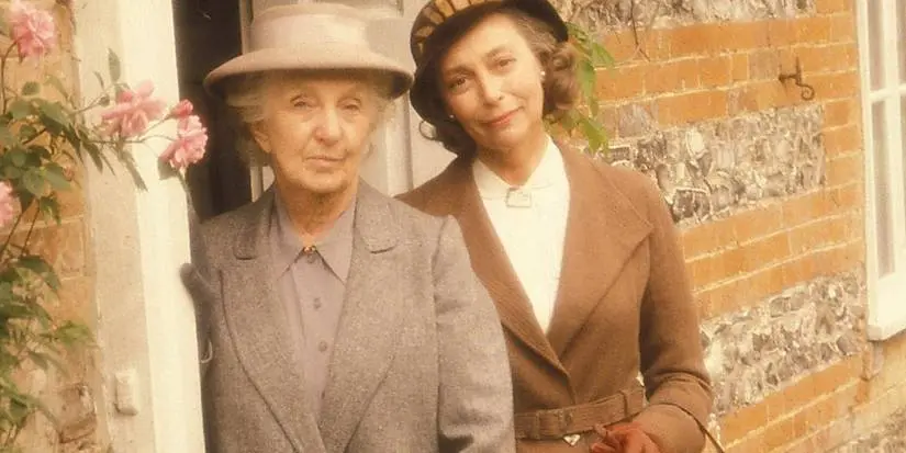 Joan Hickson as Miss Marple standing in a doorway