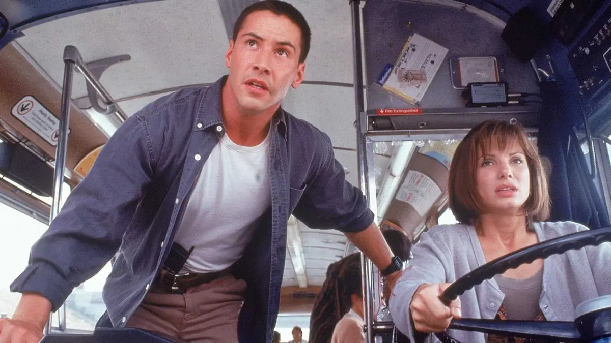 Keanu Reeves and Sandra Bullock next to each other in Speed