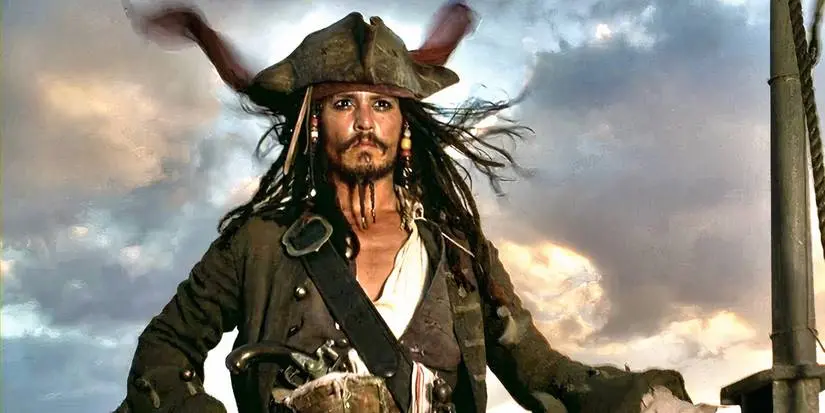 Captain Jack Sparrow standing at the top of a sinking ship and looking to the horizon in Pirates of the Caribbean: The Curse of the Black Pearl